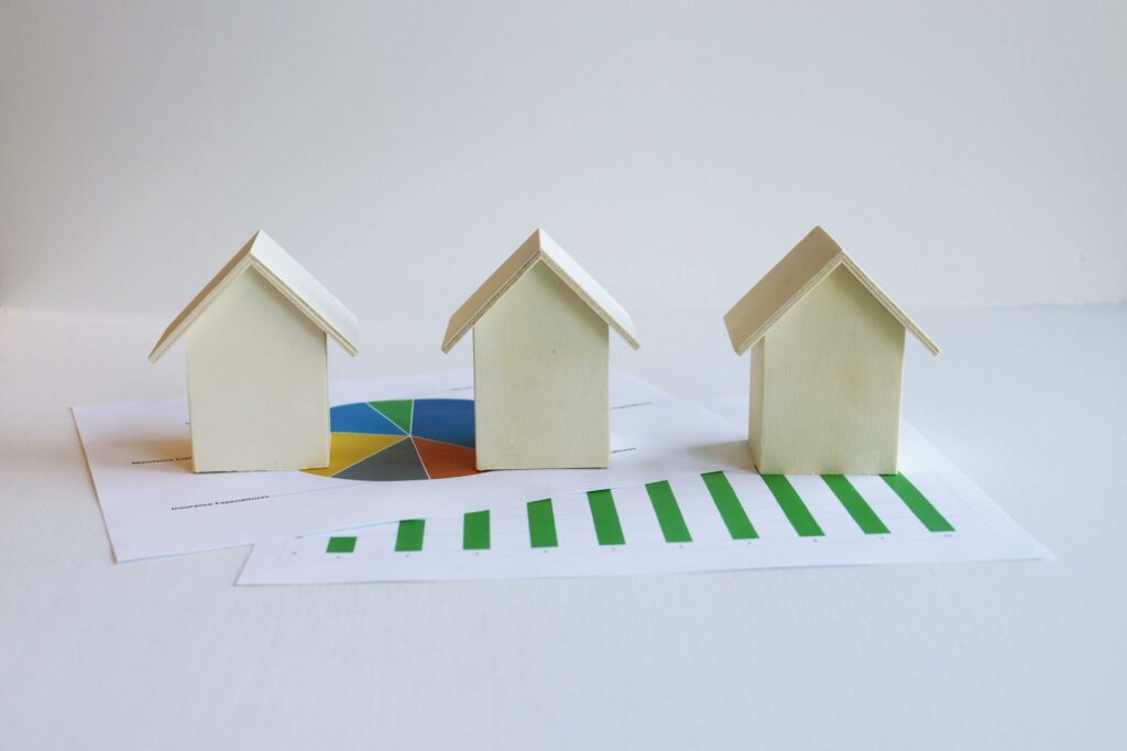 wooden model houses and printed graphs