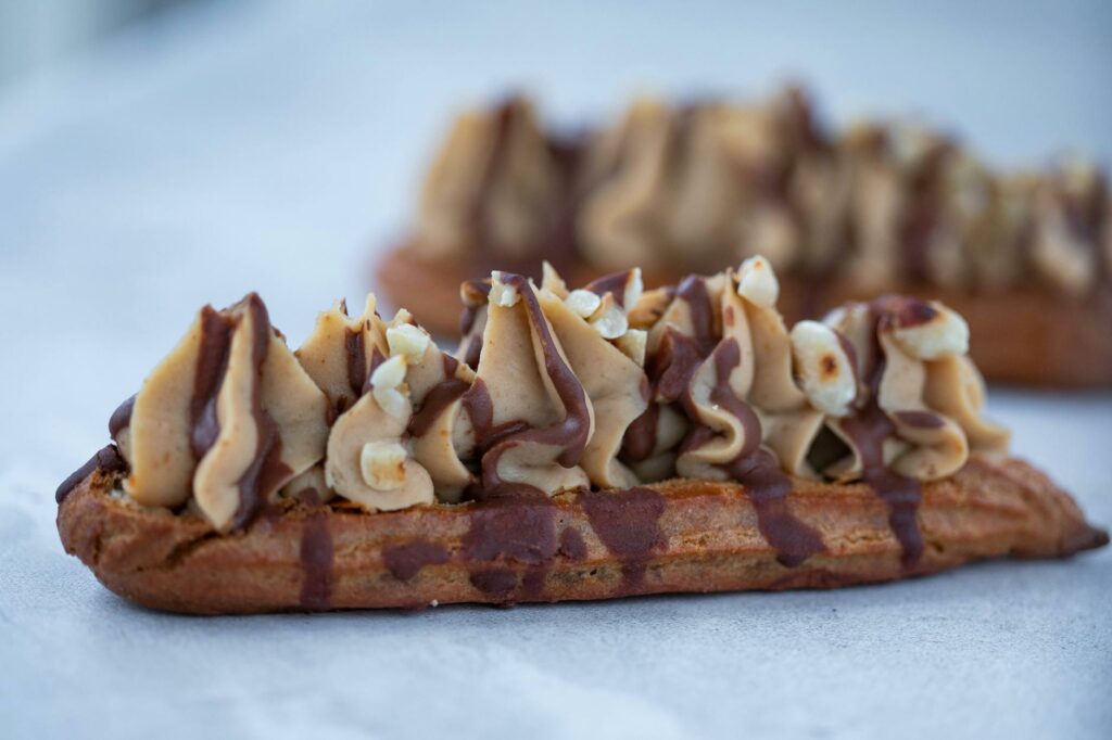 close up of an eclair with cream and chocolate