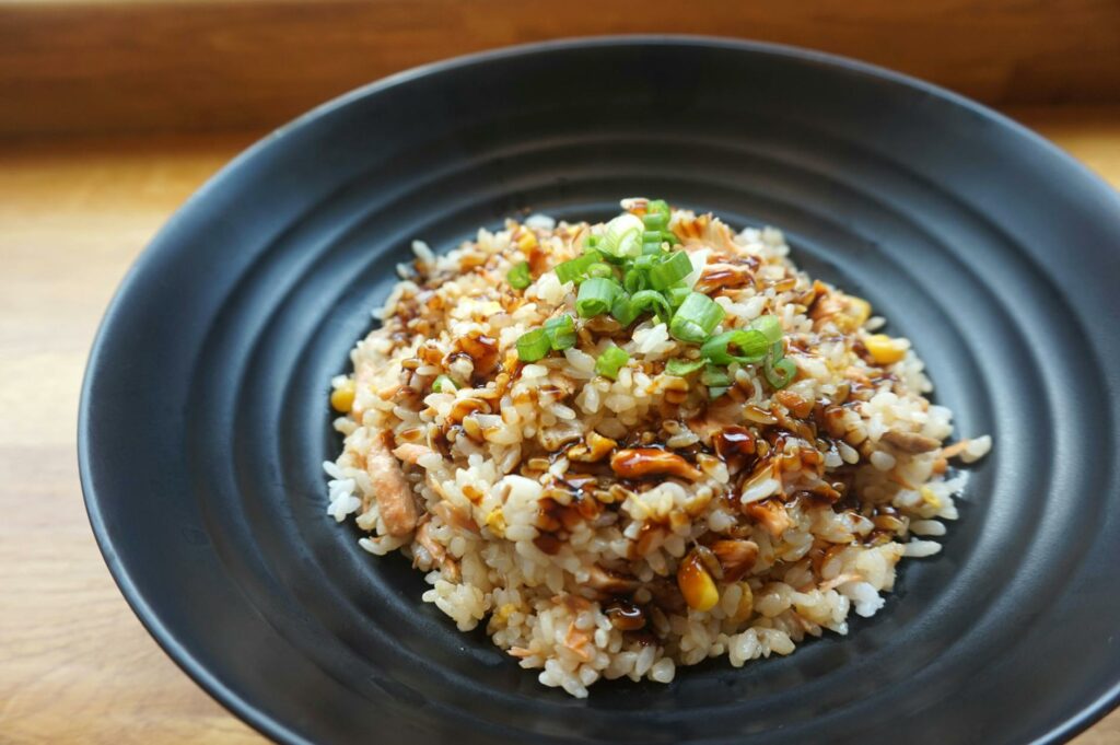 cooked rice on black ceramic plate